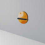 ORANGE ARRANGEMENT Oval Art Shelf In Black Finish